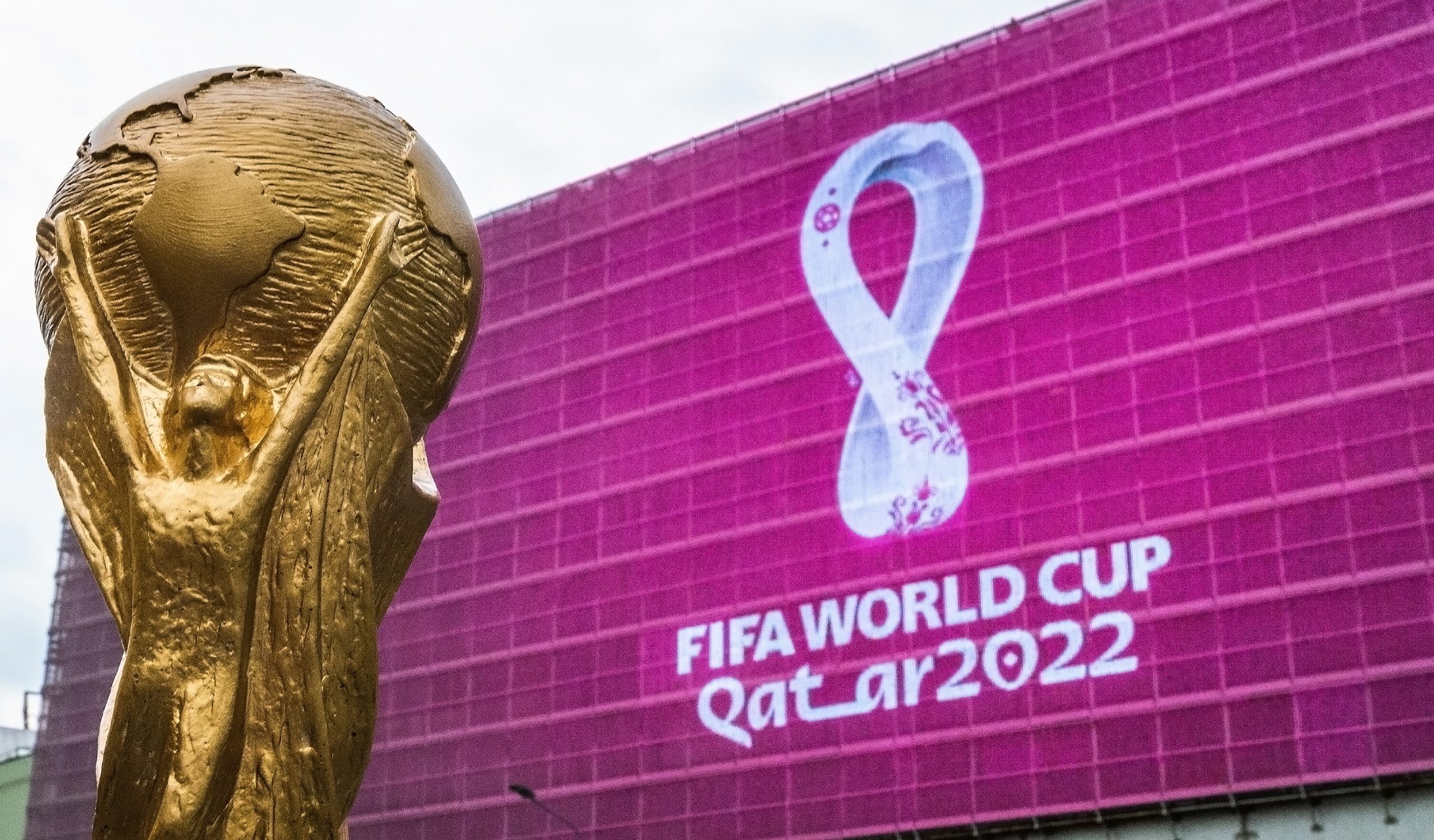 The FIFA World Cup with the Qatar 2022 logo in the background
