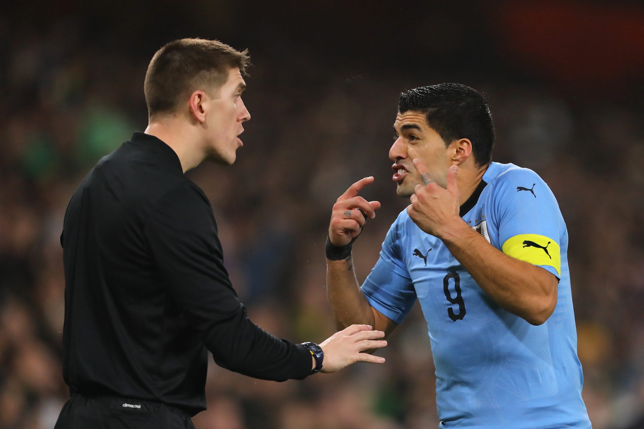 Luis Suarez arguing with the referee during a Uruguay match
